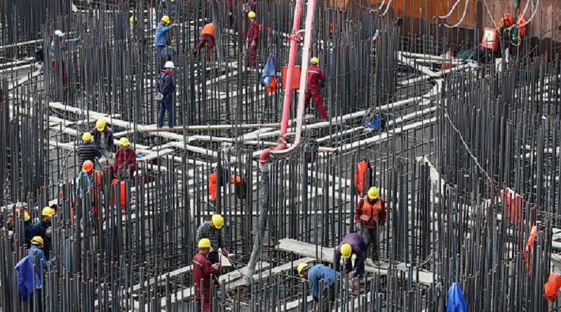 NANTONG, CHINA - NOVEMBER 08: Construction workers cast concrerte on the bearing platform of main piers of Hutong Yangtze River Bridge on November 8, 2017 in Nantong, Jiangsu Province of China. The 11,072-meter-long Hutong Yangtze River Bridge started construction in March 2014, spanning 1,092 meters on the south side and 336 meters on the north. As the world's longest cable-stayed bridge, it has a design that allows dual-use, with rails on the lower layer and a highway on the top. It will only take about one hour traveling from Shanghai to Nantong after its completion. (Photo by VCG/VCG via Getty Images)