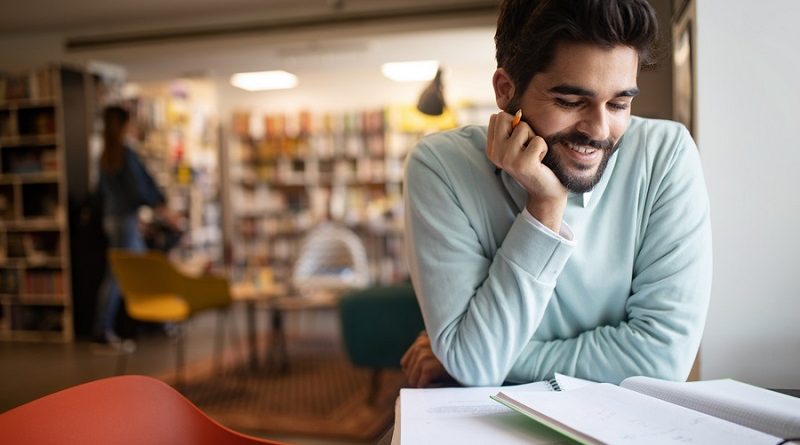 Student preparing exam and learning lessons in college library
