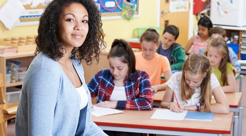 Portrait Of Teacher In Class With Pupils