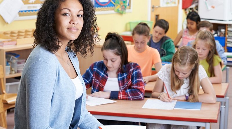 Portrait Of Teacher In Class With Pupils