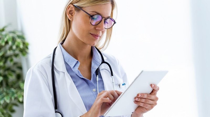 Shot of female doctor using her digital tablet in the consultation.