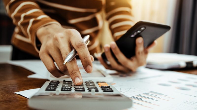 Female accountant or banker making calculation of finance and economy banking concept.