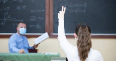 Teacher and his students wearing protective face mask in the classroom. Social distanting and classroom safety during coronavirus epidemic