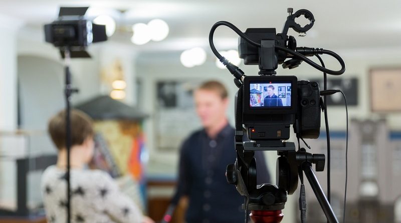 Video of the interview. Television equipment, camcorder with LCD screen, lighting equipment.