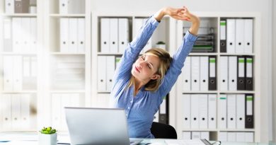 Woman Stretches At Office Desk. Stretching Exercise