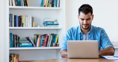 Mexican hipster man working with computer indoor at desk at home